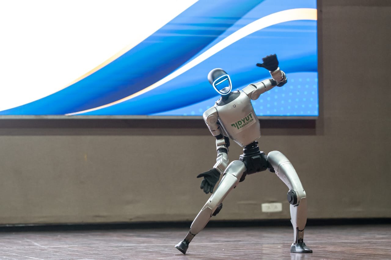 A humanoid robot performing a pose at an exhibition